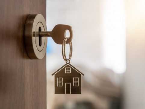 Key in a lock with a house keyring.